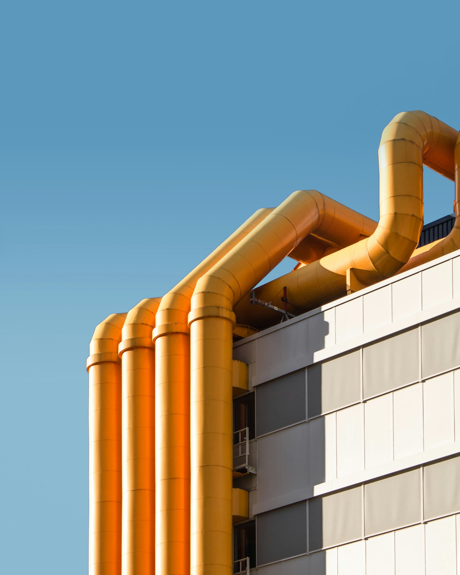 Industrial acid scrubber ductwork against a blue sky